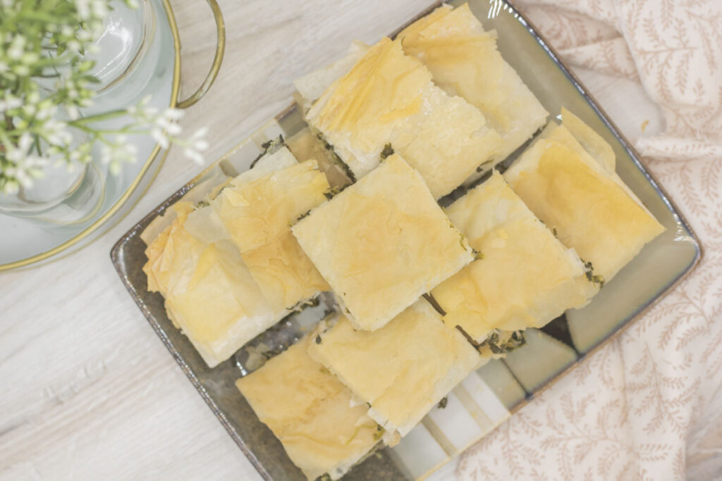 Spanakopita piled on a plate