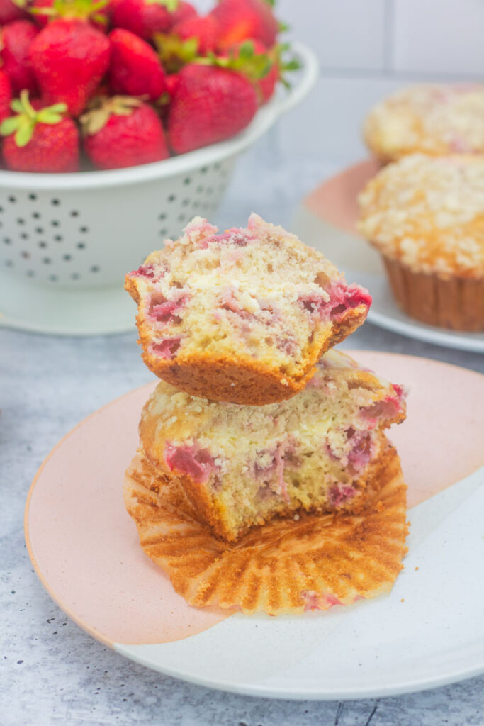 Strawberry cheesecake muffins stacked on a plate