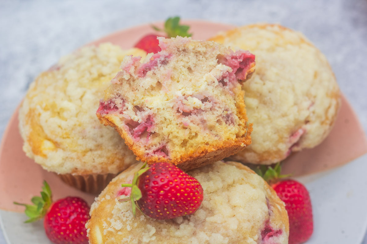Fresh strawberry cheesecake muffins with a cream cheese layer
