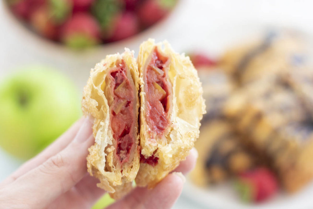 close up of a strawberry apple hand pie cut in half
