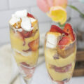 Two champagne glasses filled with strawberry parfait