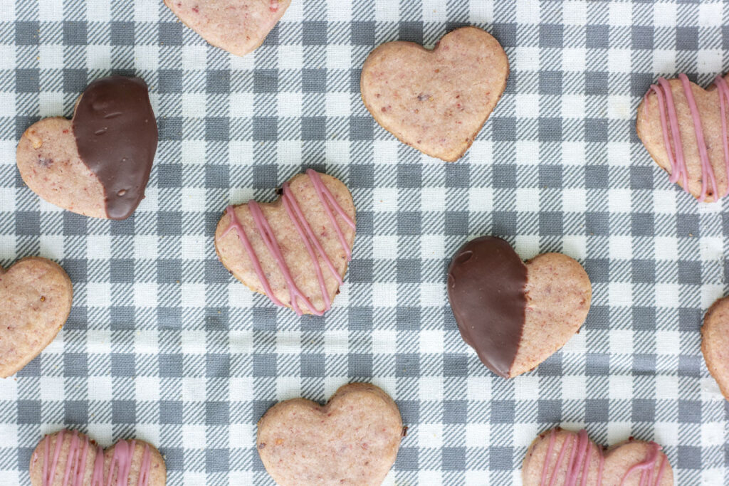 Assortment of chocolate dipped and drizzled strawberry cream cheese sugar cookies