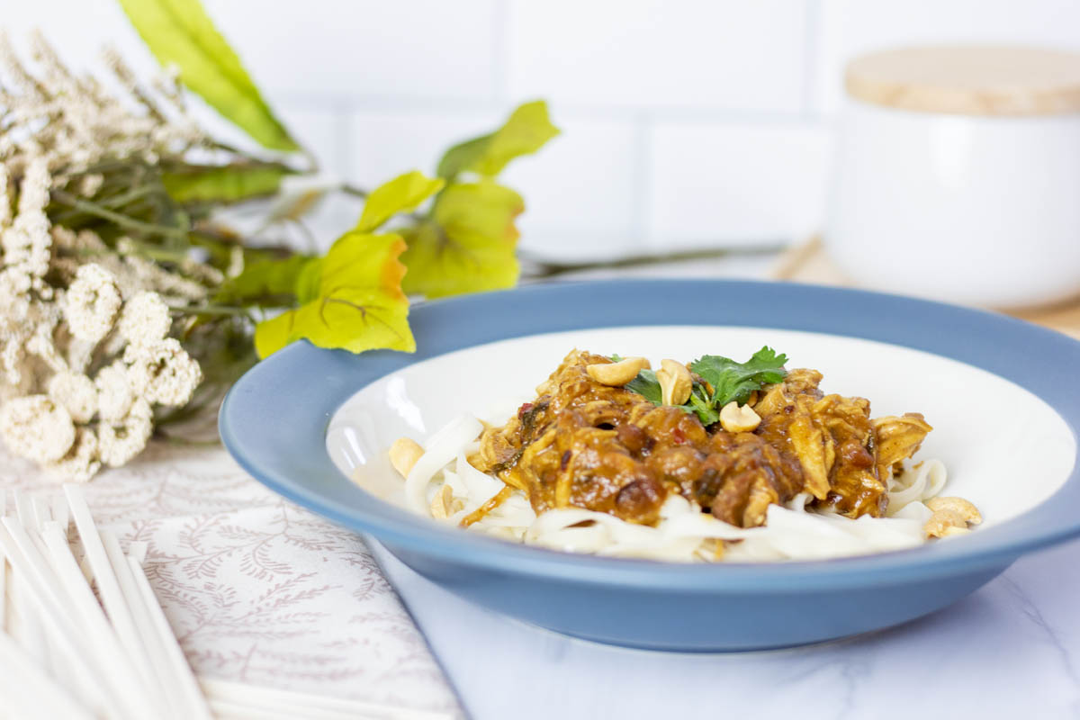 slow cooker thai peanut chicken over rice noodles