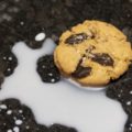 brown butter toffee chocolate chip cookie sitting on a milk splash