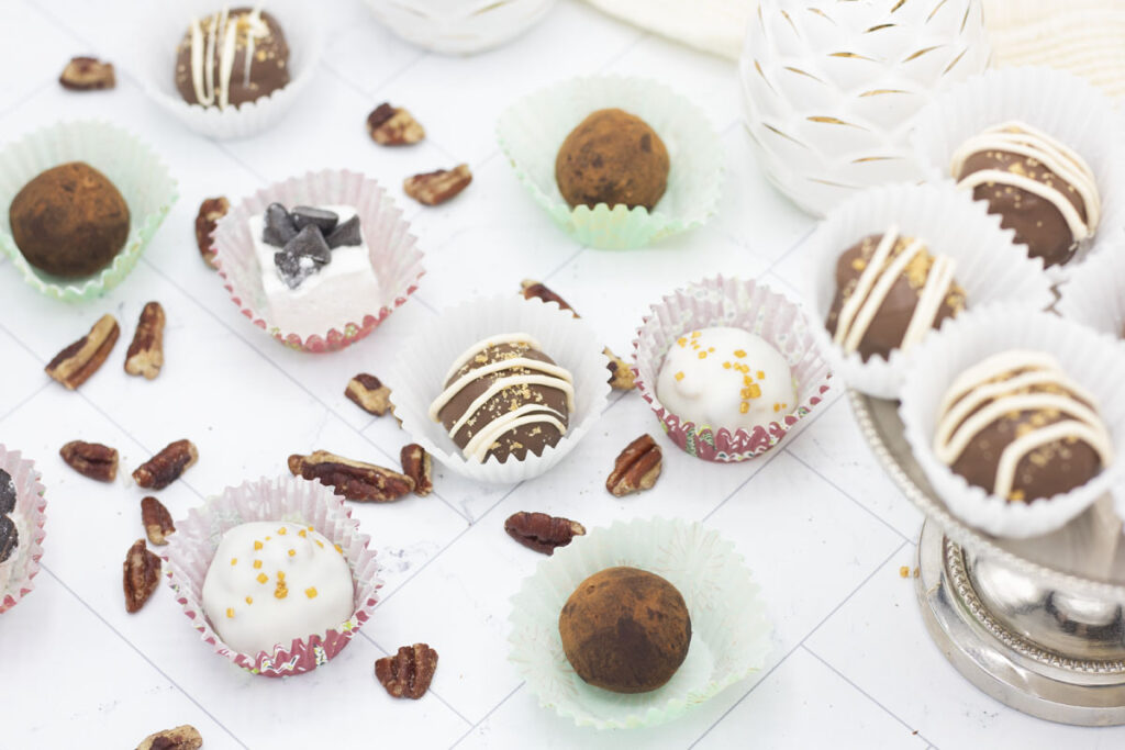 Assorted truffles with pecans scattered around