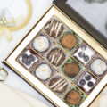 Holiday assortment of truffles in a box with bells and christmas trees