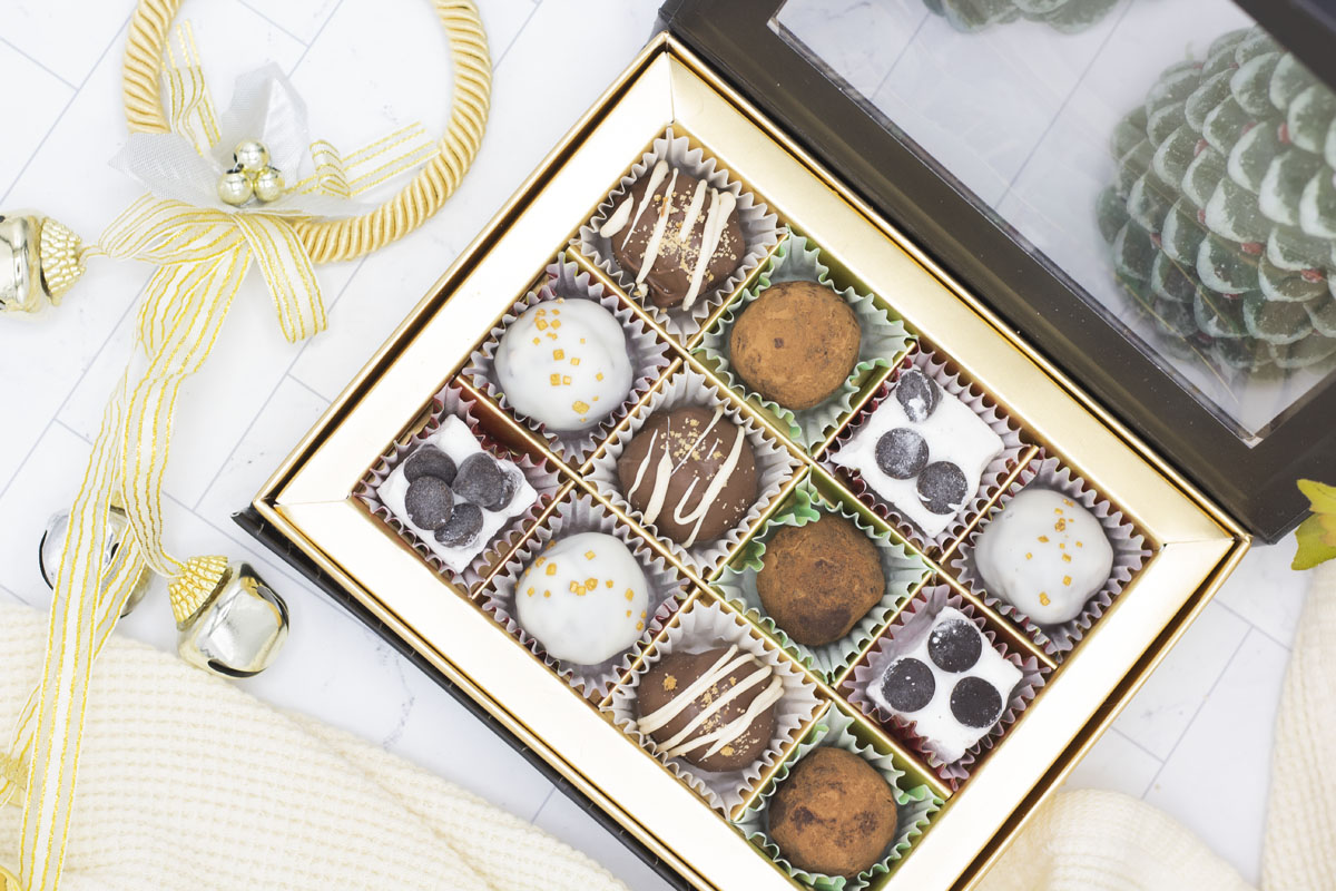 Holiday assortment of truffles in a box with bells and christmas trees