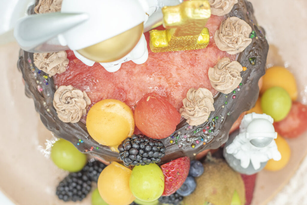 Top view of a watermelon cake with whipped cream decorations