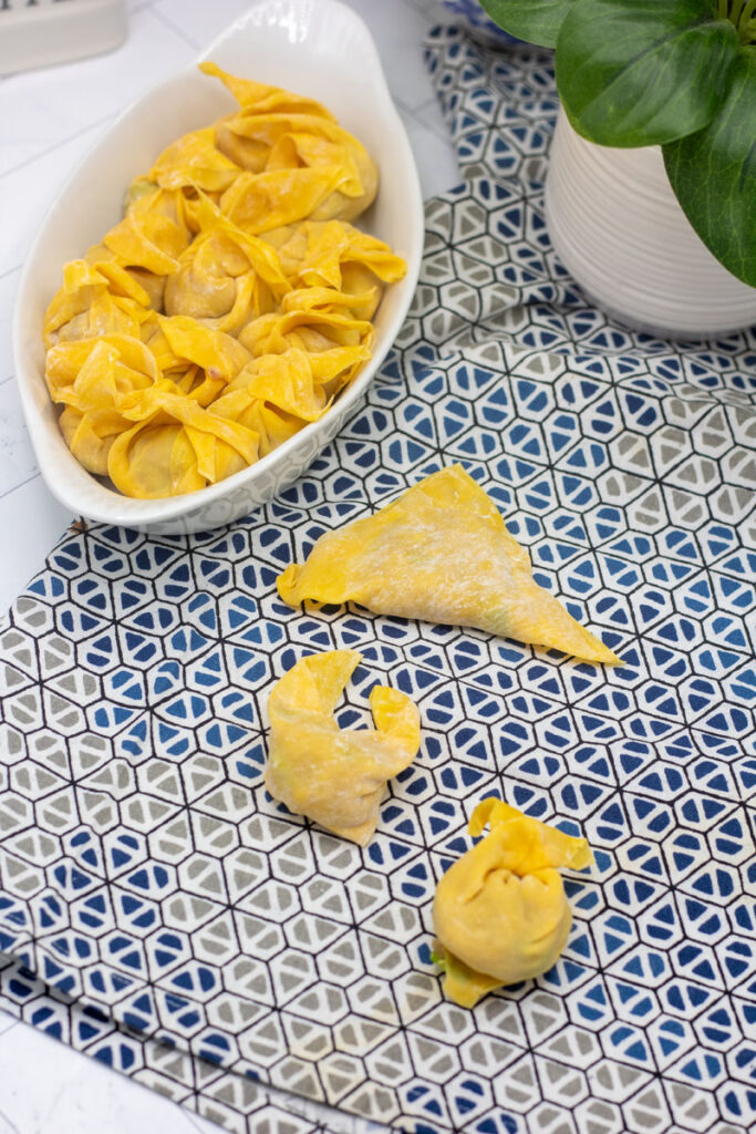 Unfolded and folded pan-fried pork wontons