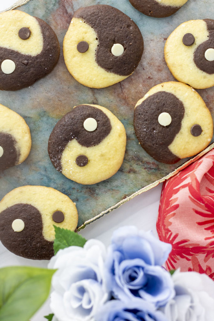 Yinyang cookies scattered on a marble board